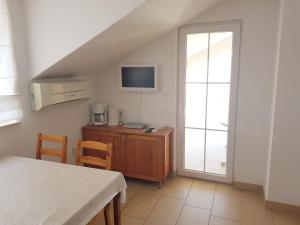a living room with a desk and a tv and a window at Apartments Palaca Sunca in Srima