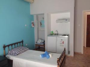 a bedroom with a large bed and a kitchen at Villa Sia in Dassia