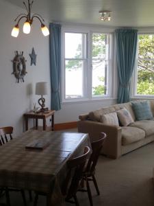 a living room with a couch and a table at Crail House Apartments in Crail