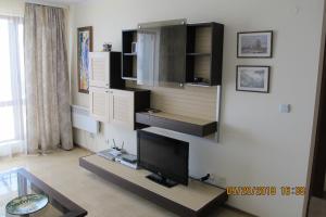 a living room with a flat screen tv on a wall at Black Sea Apartment in Nesebar