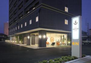 a black building with a sign in front of it at Hotel Nanvan Hamanako in Kosai