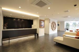 a large lobby with a couch and a large screen at Hotel Nanvan Hamanako in Kosai