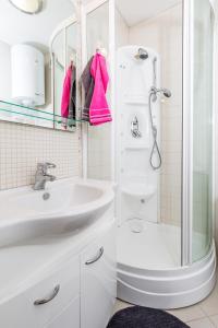a white bathroom with a sink and a shower at Smart 4 Sports Apartment in Opatija