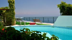 a swimming pool with a view of the ocean at Residence Eden in Furore