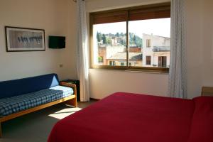 a living room with a couch and a window at Residence Circe in Taormina
