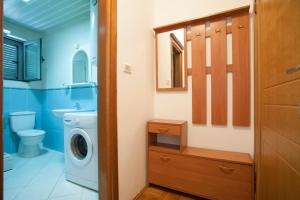 a bathroom with a washing machine and a washer at Dobrljanin LUX apartment in Budva +71 photos