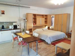 1 dormitorio con cama, mesa y cocina en Délibáb Apartment, en Budapest