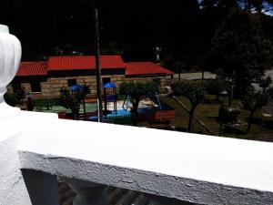 a white fence with a playground in the background at Mar de Rosas in O Grove