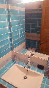a bathroom with a sink and a mirror at Appartamento Aldiola in Porto Rotondo