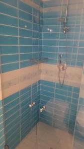 a bathroom with a shower with blue tiles at Appartamento Aldiola in Porto Rotondo