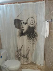 a drawing of a woman in a hat on a shower curtain at Casa Colonial Yadilis y Yoel in Havana
