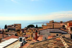 a view of a city from the roofs of buildings at Residence Circe in Taormina +27 photos