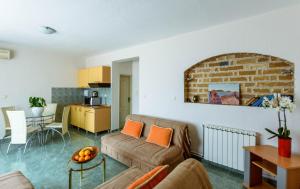 a living room with a couch and a brick wall at Contessa Apartments in Budva