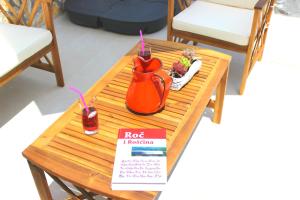 a table with a red jug and a drink on it at Holiday Home Deni in Roč