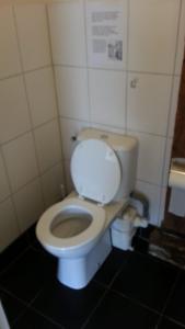 a bathroom with a white toilet in a stall at studio-appartement in paardenstal in Colijnsplaat