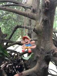 a toy doll is hanging from a tree at Baan Bon Resort Bang Tabun in Phetchaburi