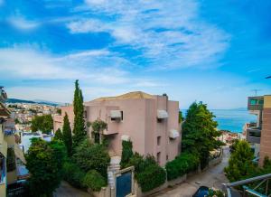 a building in a city with trees and the ocean at Sea Breeze Flat in Kavála