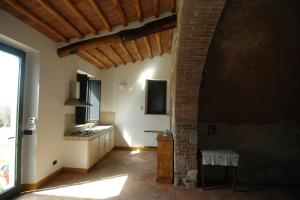 a kitchen with a large window and a brick wall at La Fornace di San Galgano in Chiusdino