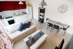 a living room with a couch and a table and a kitchen at Sea Breeze Flat in Kavala