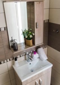 a bathroom with a sink and a mirror at Sea Breeze Flat in Kavála +37 photos