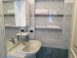 a bathroom with a sink and a mirror and towels at La casetta della nonna in Sestri Levante
