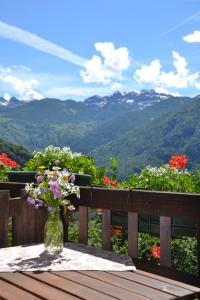 a vase of flowers on a table with a view at B&B Marcellina in Bard