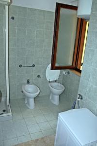 a bathroom with a toilet and a sink and a mirror at Residence Torretta in Mazara del Vallo