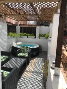 an outdoor patio with a jacuzzi tub and benches at Atico En El Centro in Valencia