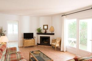 a living room with a fireplace and a tv at Casa Lulu in Marbella