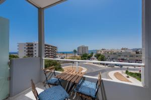 a balcony with two chairs and a view of a street at MV83 new marina in Rhodes Town