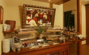 eine Theke mit einem Buffet mit Speisen und einem Spiegel in der Unterkunft Hotel Schweizer Hof - Superior in Baden-Baden