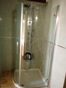 a shower with a glass door in a bathroom at Hotel Corsaro Nero in Portu Maga