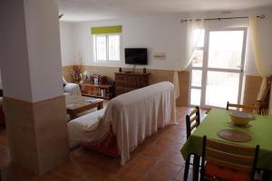 a living room with a bed and a table at Casa Leonora in Huércal-Overa
