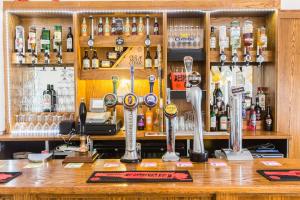 a bar with lots of bottles of alcohol at The Swan in Thornbury