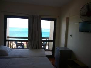 a bedroom with a bed and a view of the ocean at Royal Crown Hotel Marsa Matruh in Marsa Matruh