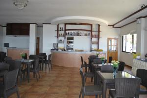 a restaurant with tables and chairs and a bar at Lagoon beach resort in Gitagun