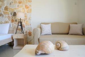 a living room with a couch and a shell on a table at Agorastos Hotel in Koinyra