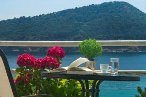 a table with books on it with a view of the water at Agorastos Hotel in Koinyra
