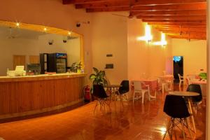 a restaurant with a bar and tables and chairs at Evila Inn - Thoddoo in Thoddoo