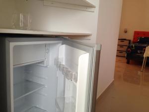 a refrigerator with its door open in a kitchen at Hotel Almond Beach in Tonsupa