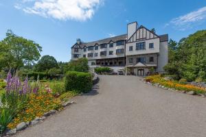 a large building with a garden in front of it at Benbow Historic Inn in Garberville