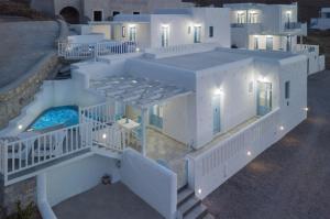 an aerial view of a white house with a swimming pool at Aegean Sea Villas in Livadi Astypalaias