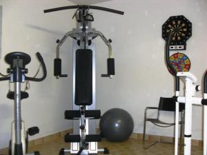 a gym with two exercise bikes and a ball at Hotel garni Landhaus Bürtlmair in Hinterstoder