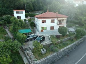 a car is parked in front of a house at Perla Apartments Opatija - apartments with sea view in Opatija