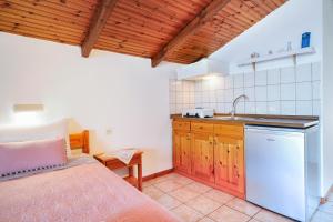 a kitchen with a bed and a sink in a room at Studios Niki in Koinyra