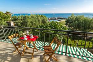 a table and chairs on a balcony with the ocean at Apartment Veve in Privlaka