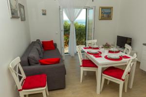 a living room with a table and a couch at Apartment Veve in Privlaka