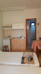 a kitchen with a table and a counter top at Esperides in Batsi +39 photos