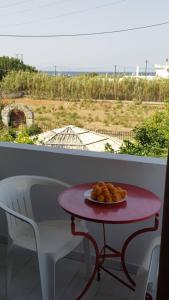 a table with a plate of food on a balcony at Esperides in Batsi
