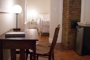 a dining room with a table and a bedroom at Russelltown Inn in Bonavista